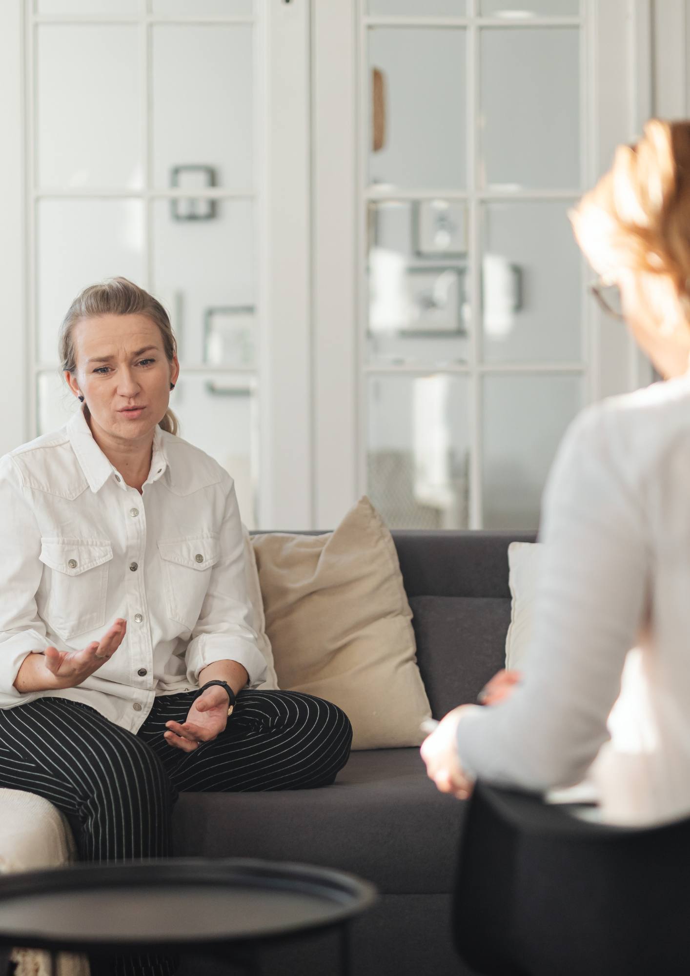 Woman talking with a psychologist in a calm, comfortable therapy room